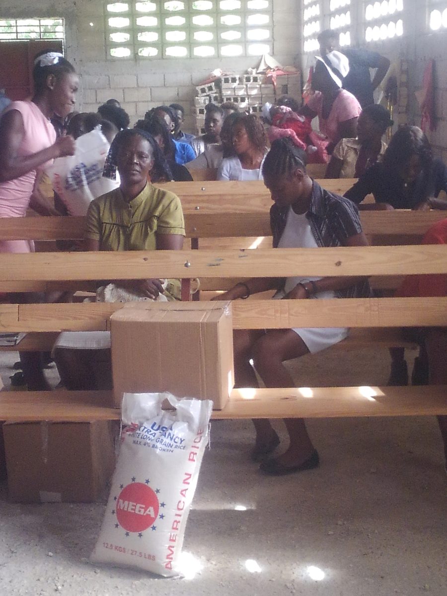 Families gathered inside the church as food packages are handed out