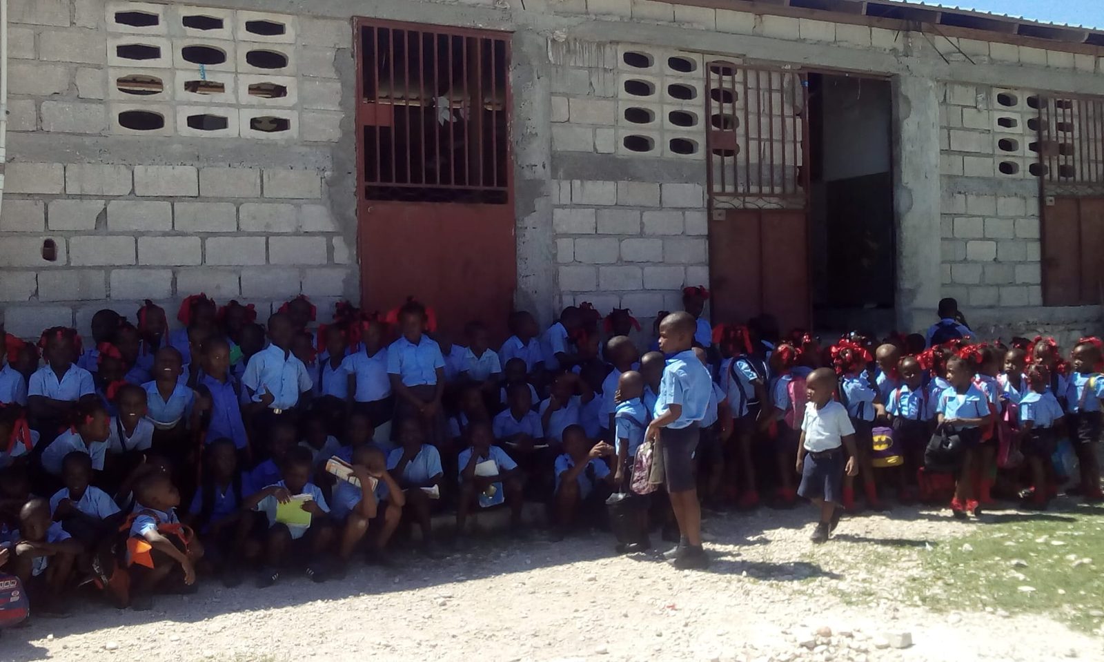 Students gathered in the schoolyard at Institution Alexandre Campbell