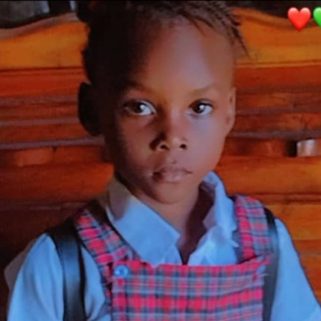 Esther, a young student in a checked school uniform, standing outside