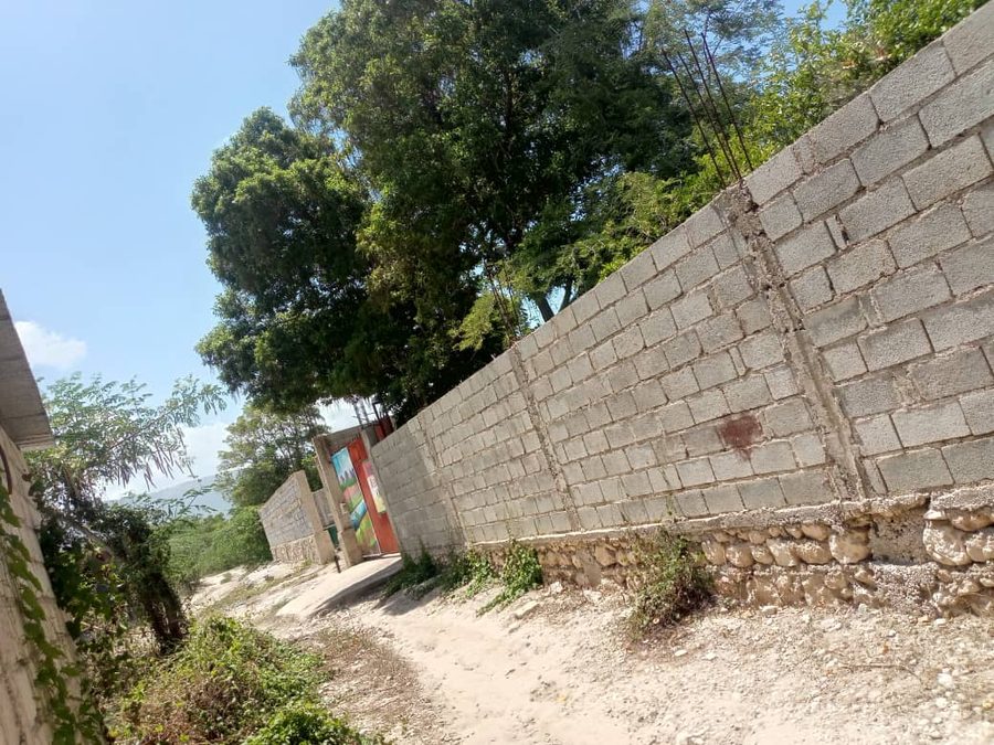 The finished section of the concrete-block wall along the school property