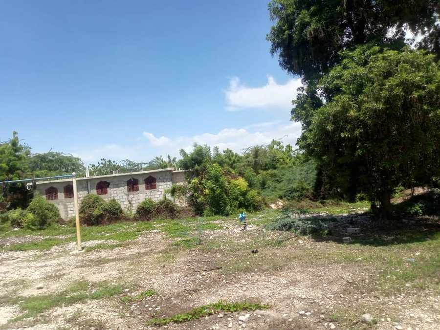 The open, unenclosed side of the school property with no wall