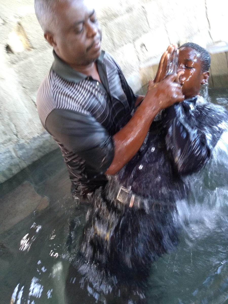 A pastor baptizing a new believer in the water